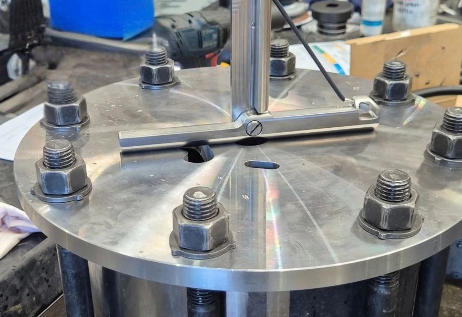 Stainless Tee Latch with a vertical ROV handle, set across a hole in a bolted steel test plate in the Blakemere workshop