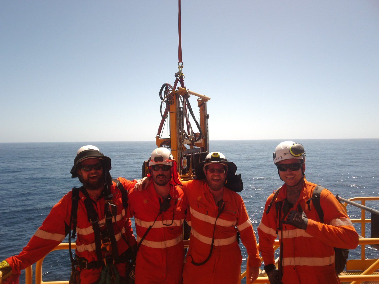 Four Blakemere crew on deck alongside subsea tooling on the crane hook
