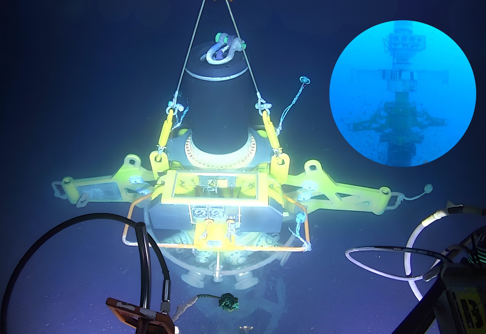 The wellhead connection system being lowered to the seabed, with an inset of it landed on the wellhead