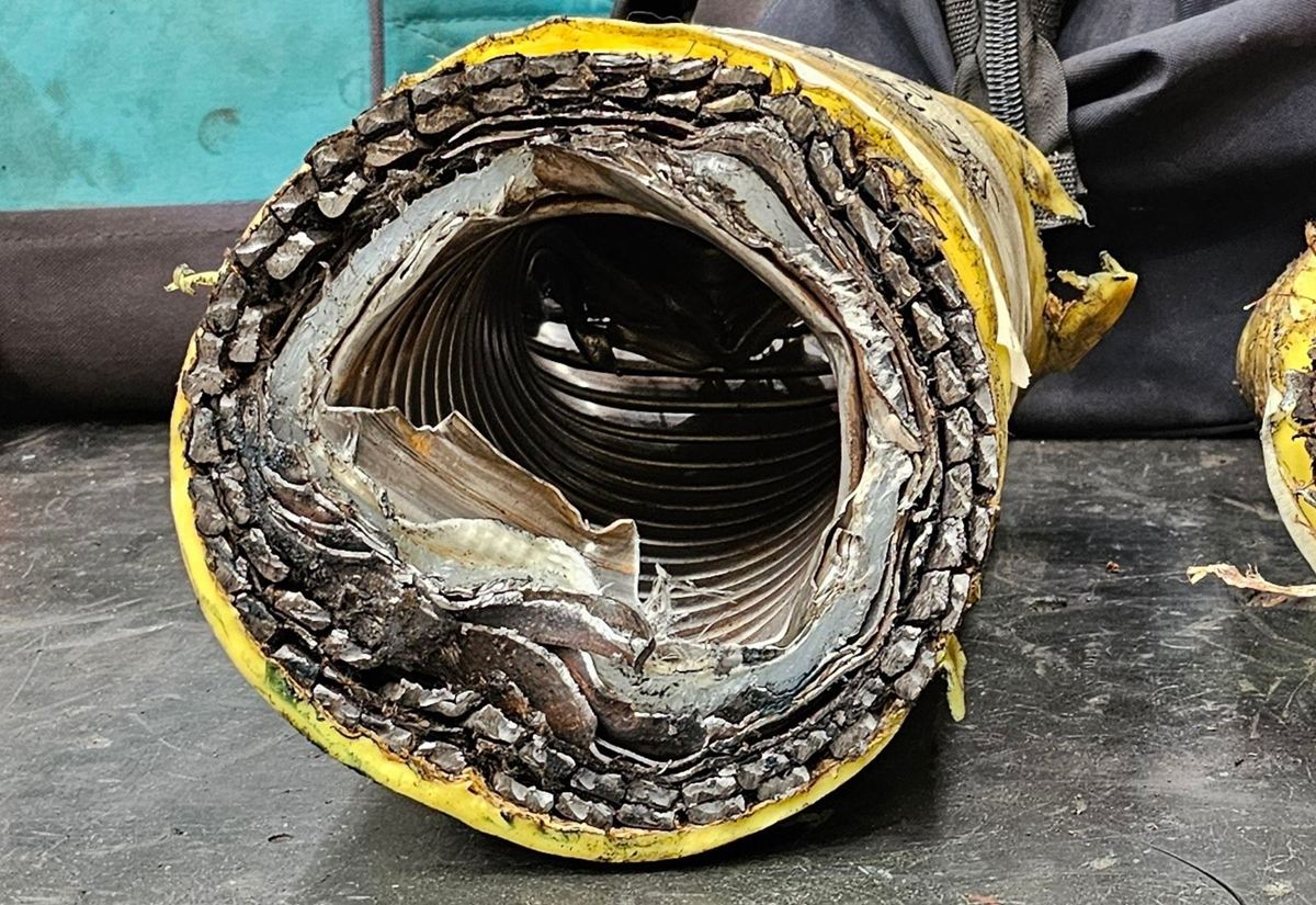 The end of the same flexible flowline cut by the open bore shear, with the bore open and round