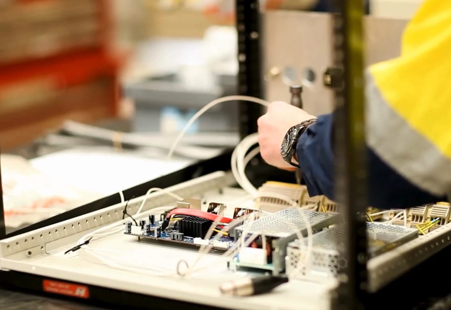 A Blakemere team member wiring the electronics of one of our printers on the workshop bench