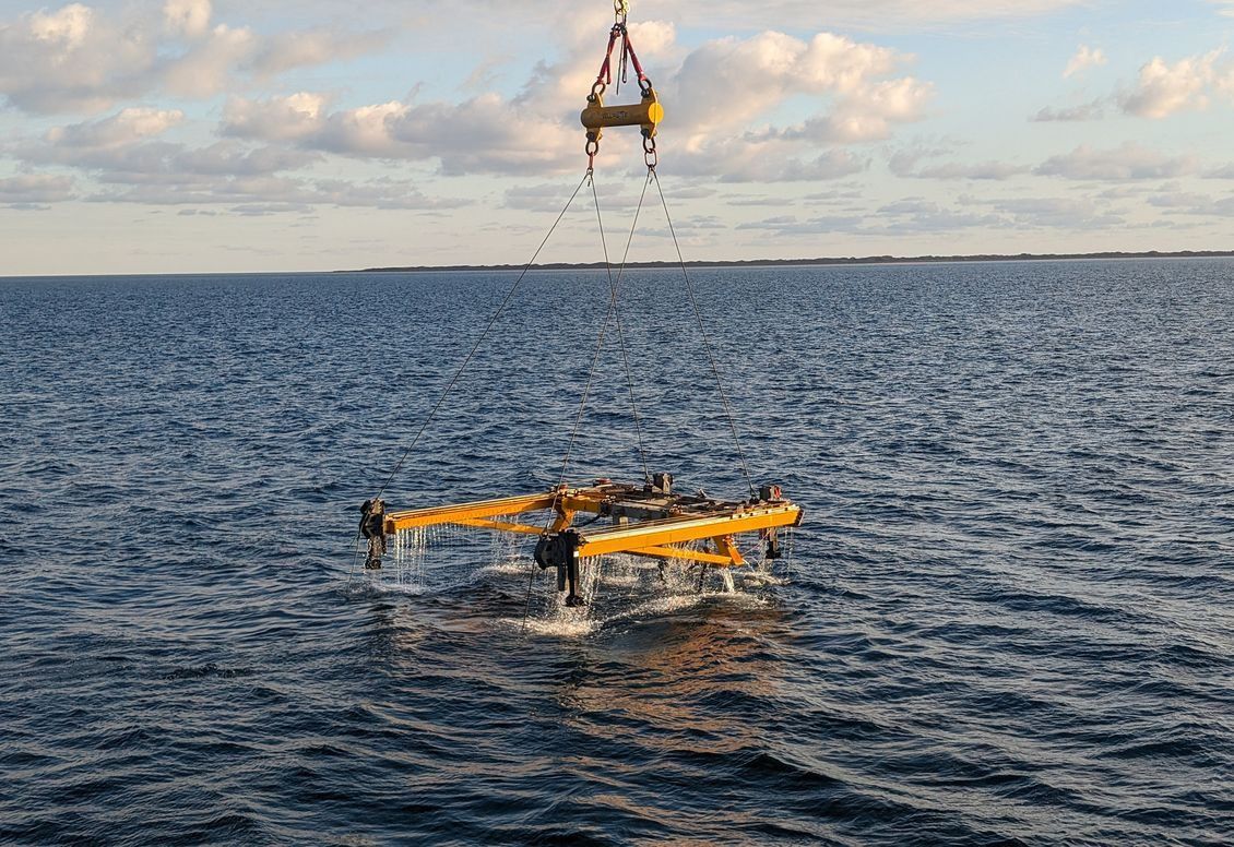 A subsea intervention frame being deployed through the splash zone
