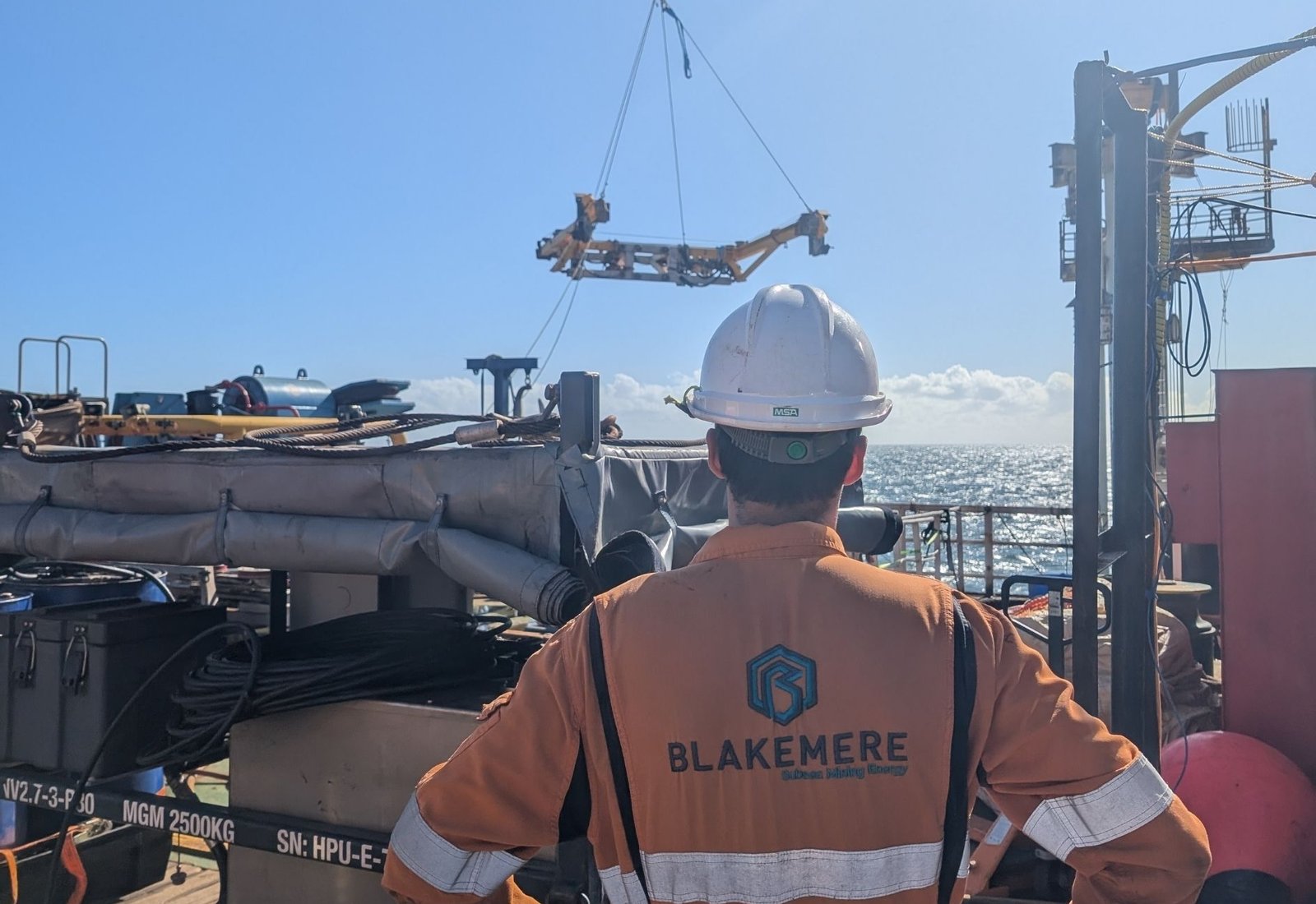 A Blakemere technician on a vessel back deck watching a cutting frame lifted clear by the crane
