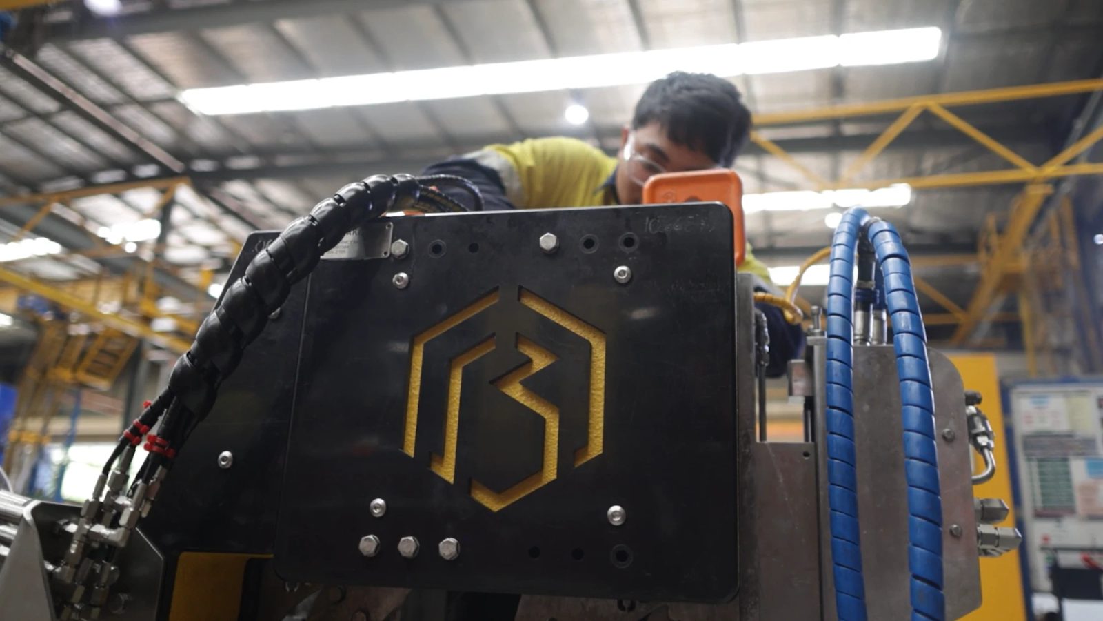 A Blakemere technician working behind a tool frame, the Blakemere mark cut through its black front plate