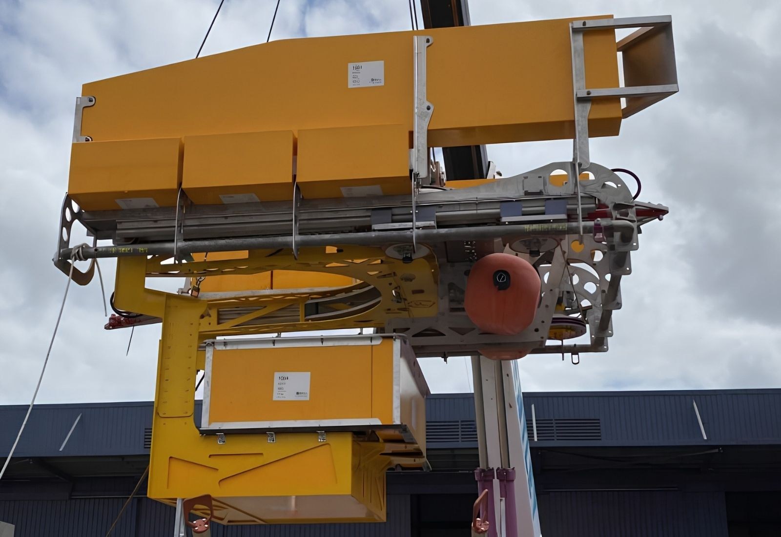 The assembled caisson cutting package on the crane, the saw frame and coupon catcher mounted on the basket deployment frame