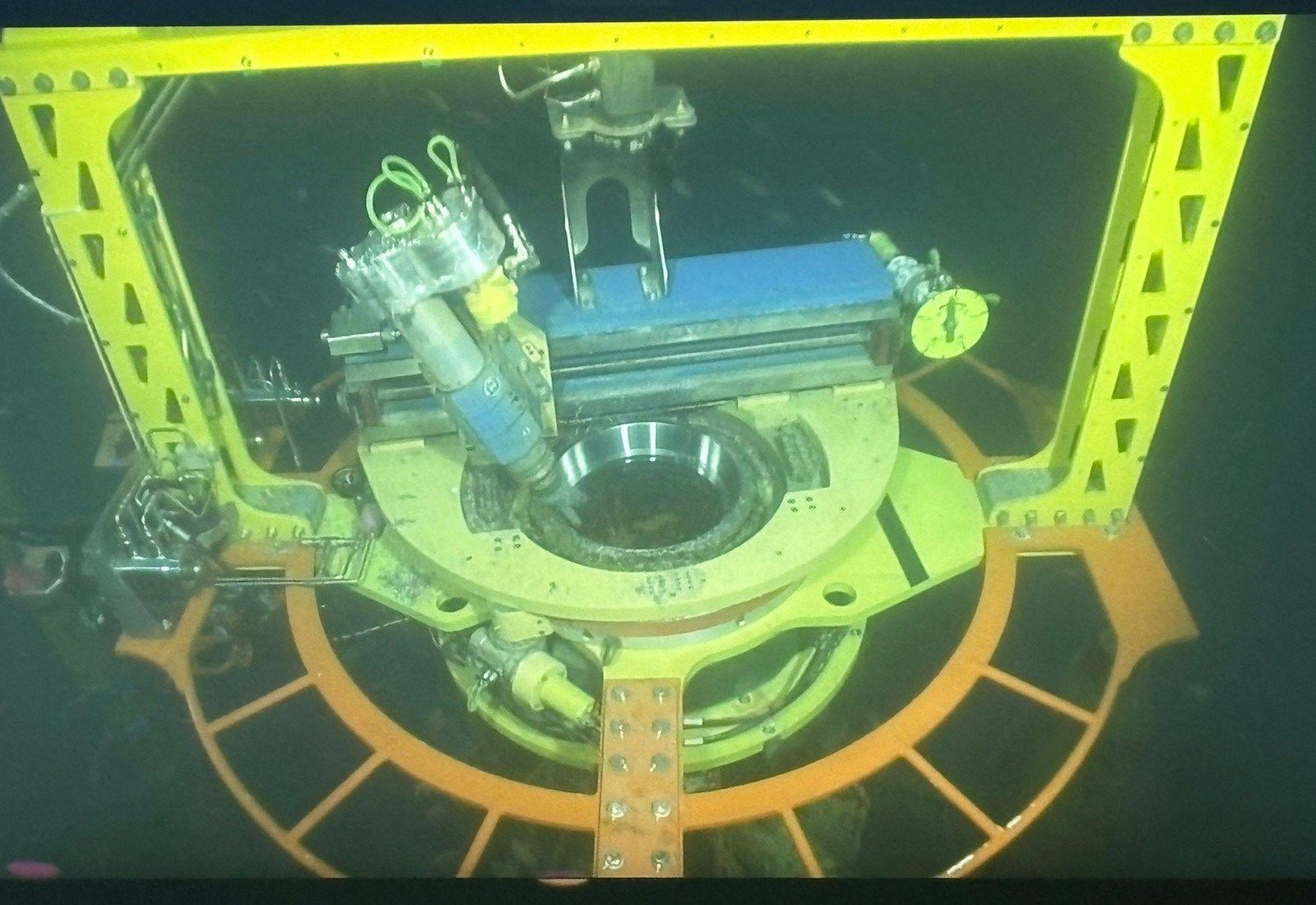 The machining tool clamped to the wellhead, cutter head orbiting the bore